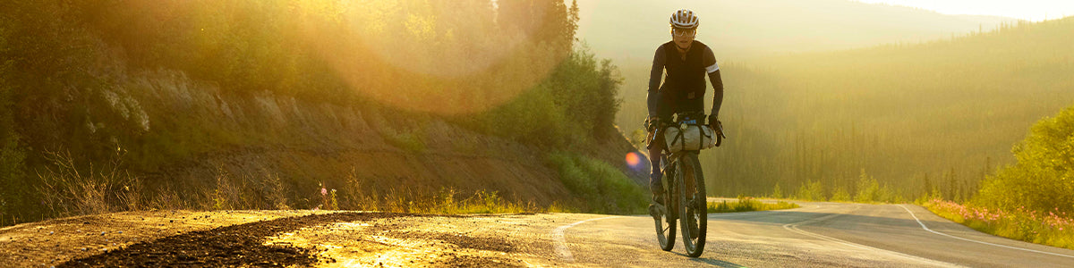 Lael Wilcox riding at sunset with Tread Labs insoles for cycling shoes